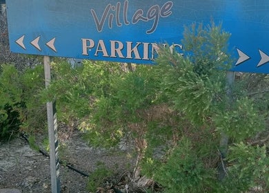 Parking area sign at Recharge Remedial And Sports Massage, Roleystone, Western Australia, AU surrounded by greenery.