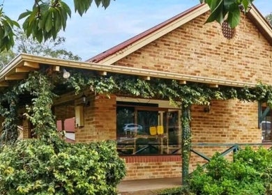 Charming brick exterior of Recharge Remedial And Sports Massage, Roleystone, with lush vines and greenery.