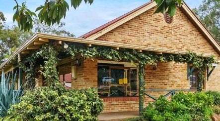 Charming brick facade of Recharge Remedial And Sports Massage in Roleystone, Western Australia, AU surrounded by greenery.