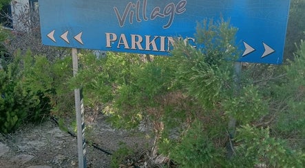Village parking sign surrounded by greenery at Recharge Remedial And Sports Massage, Roleystone, Western Australia, AU.