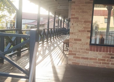 Wooden veranda outside Recharge Remedial And Sports Massage, Perth, Western Australia, AU, featuring scenic views.