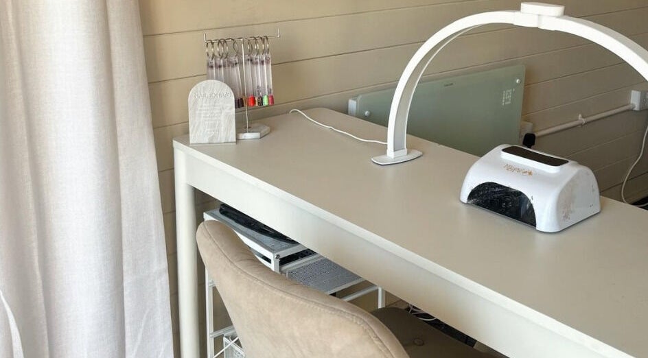 Elegant nail station at Sunflower Beauty, Baldock, England, GB featuring a modern workspace and comfy chair.