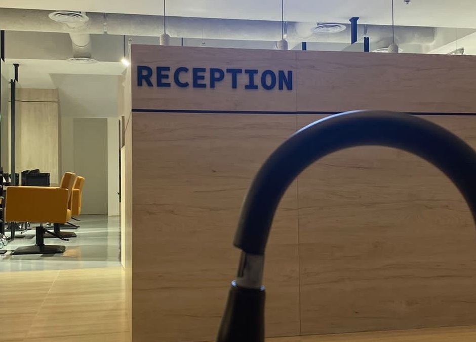 Polished salon reception with stylish yellow chairs in Al Khobar, Eastern Province, SA.