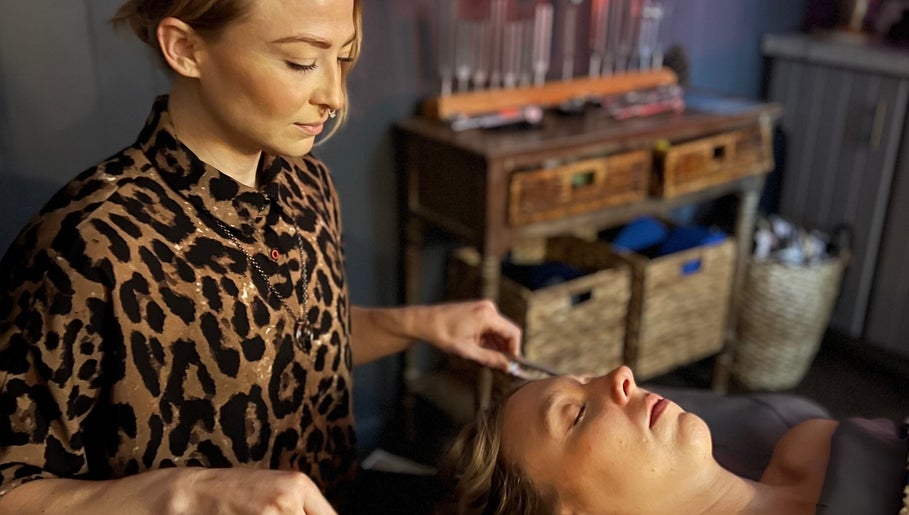 Therapist provides calming face massage at The Root Wellness Center, Caro, Michigan, US.