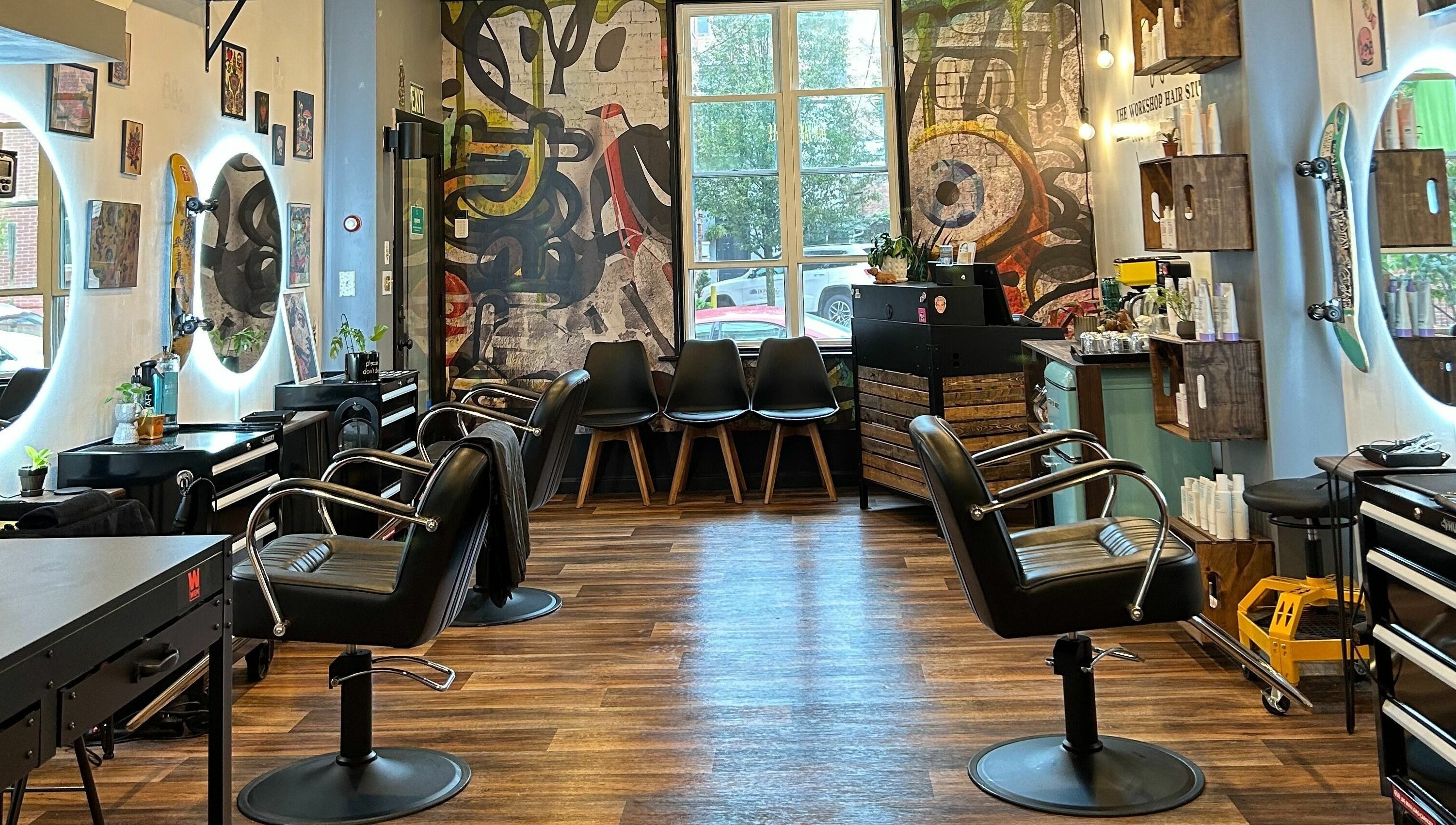 Interior of The Workshop Hair Studio in Lancaster, Pennsylvania, US, featuring chic salon chairs and vibrant decor.