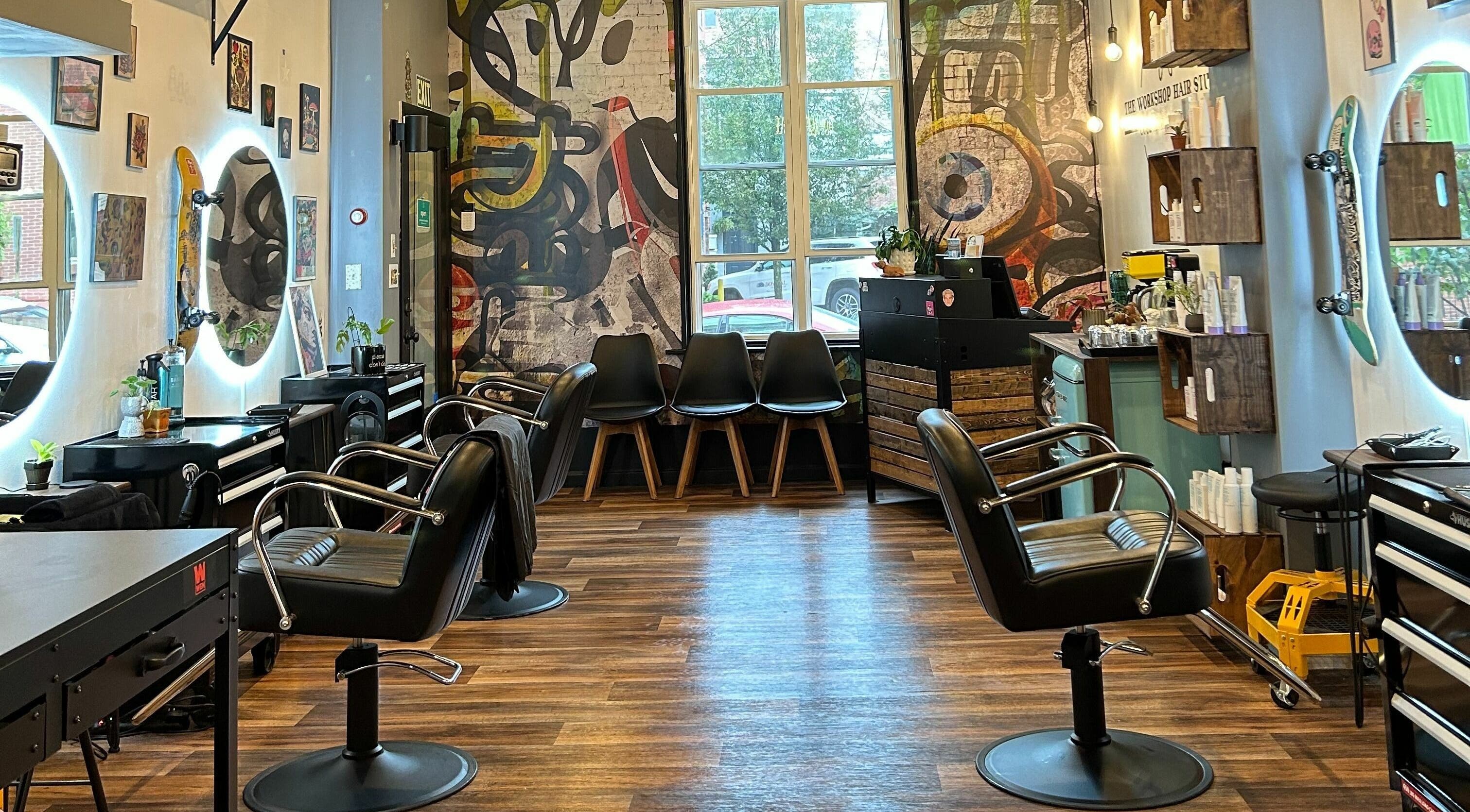 Interior of The Workshop Hair Studio in Lancaster, Pennsylvania, US, featuring chic salon chairs and vibrant decor.