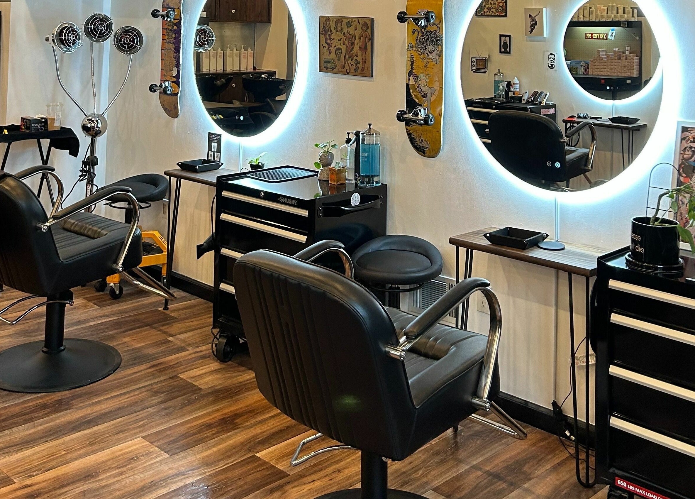 Sleek interior of The Workshop Hair Studio in Lancaster, Pennsylvania, US, showcasing modern styling chairs and mirrors.