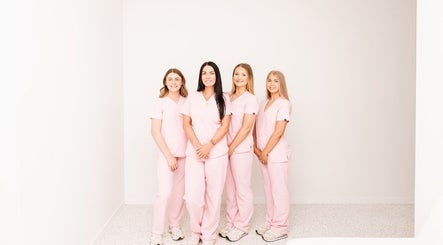 About Face team in pink uniforms at Taree, New South Wales, AU. Professional and welcoming beauty staff.