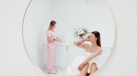 Elegant spa setting at About Face, Taree, New South Wales, AU with a client in white and staff in pink.