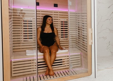 Woman relaxing in a modern sauna at About Face, Taree, New South Wales, AU. Experience serene wellness.