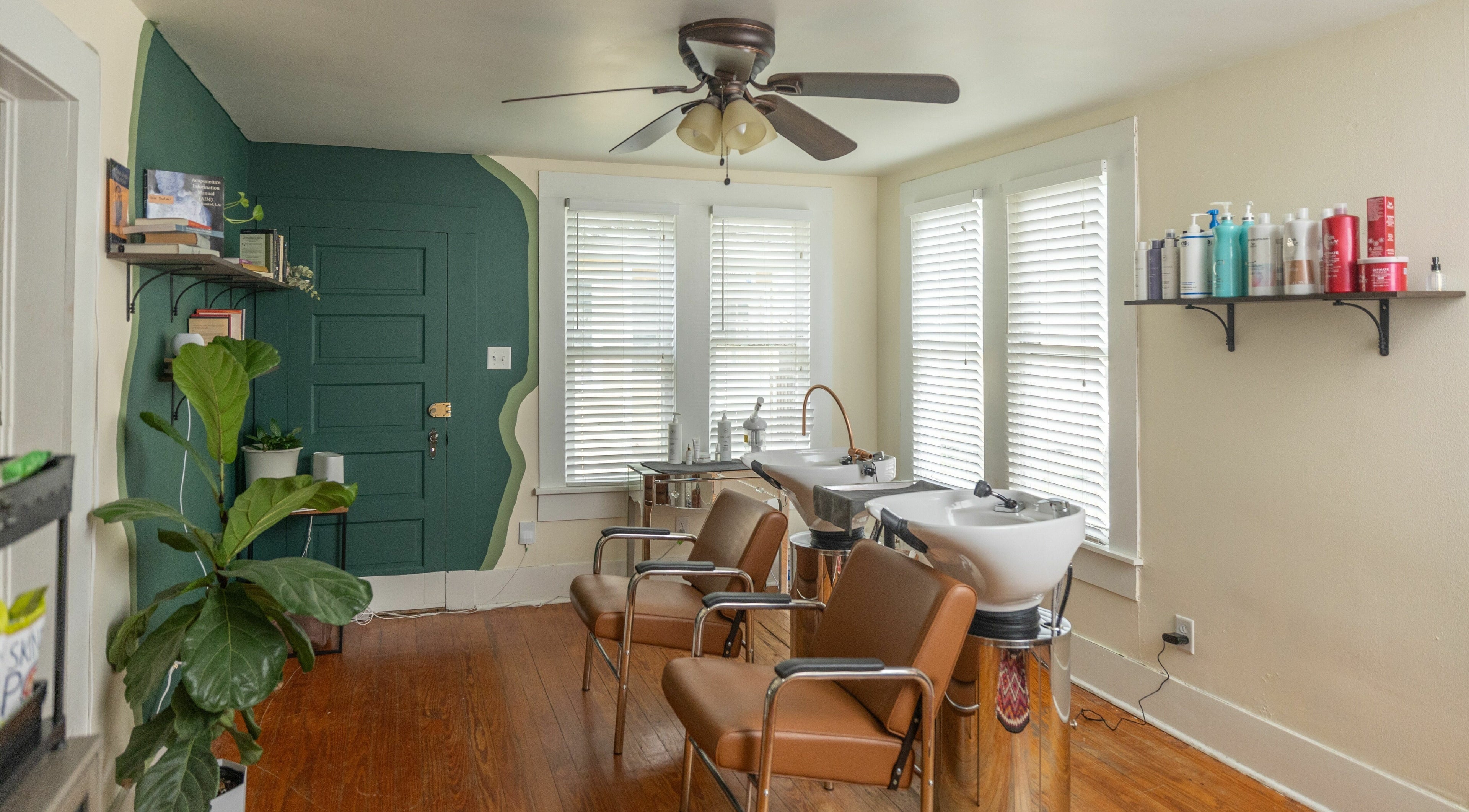 Modern salon chairs and wash station at Awaken Bastrop Energetic Salon in Bastrop, Texas, US.