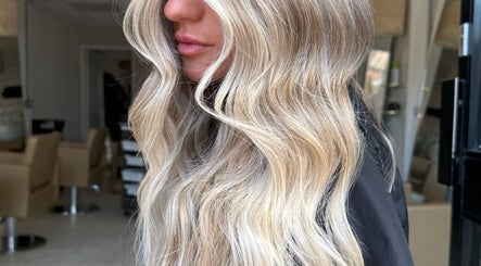 Elegant blonde waves styled at saradoeshair in Stoke-on-Trent, England, GB. Perfect for a glam look.
