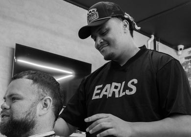 Barber styling hair at Lighthouse Barbers, Melbourne, Victoria, AU.