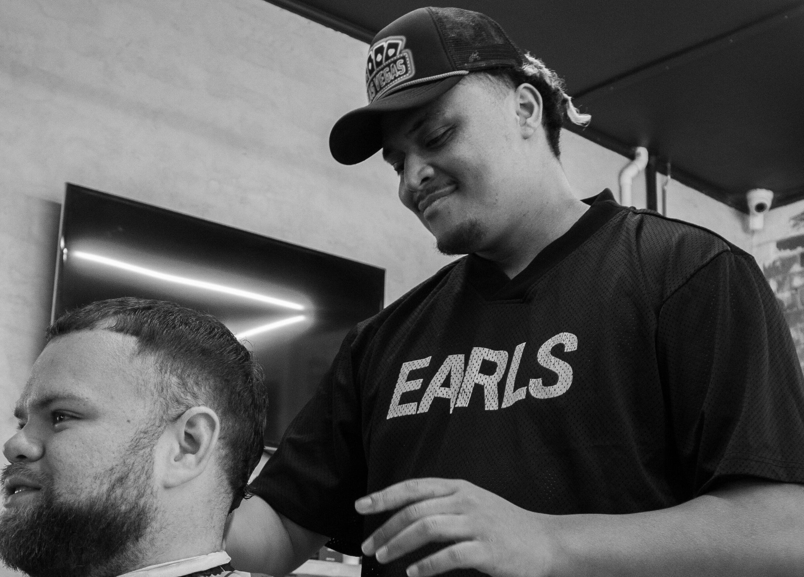 Barber styling hair at Lighthouse Barbers, Melbourne, Victoria, AU.