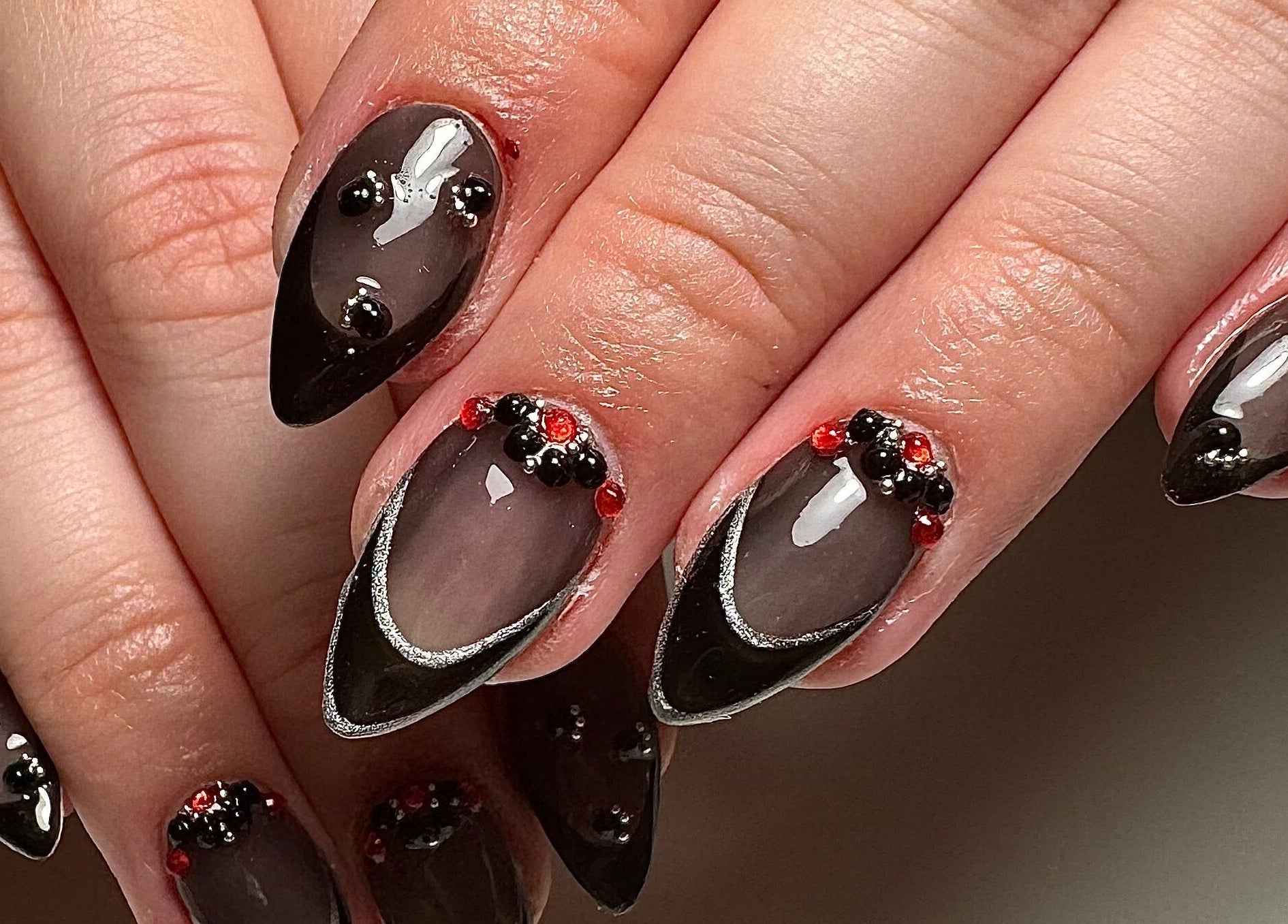 Elegant black and red decorated nails at Gloxy Nails, Banbridge, Northern Ireland, GB.