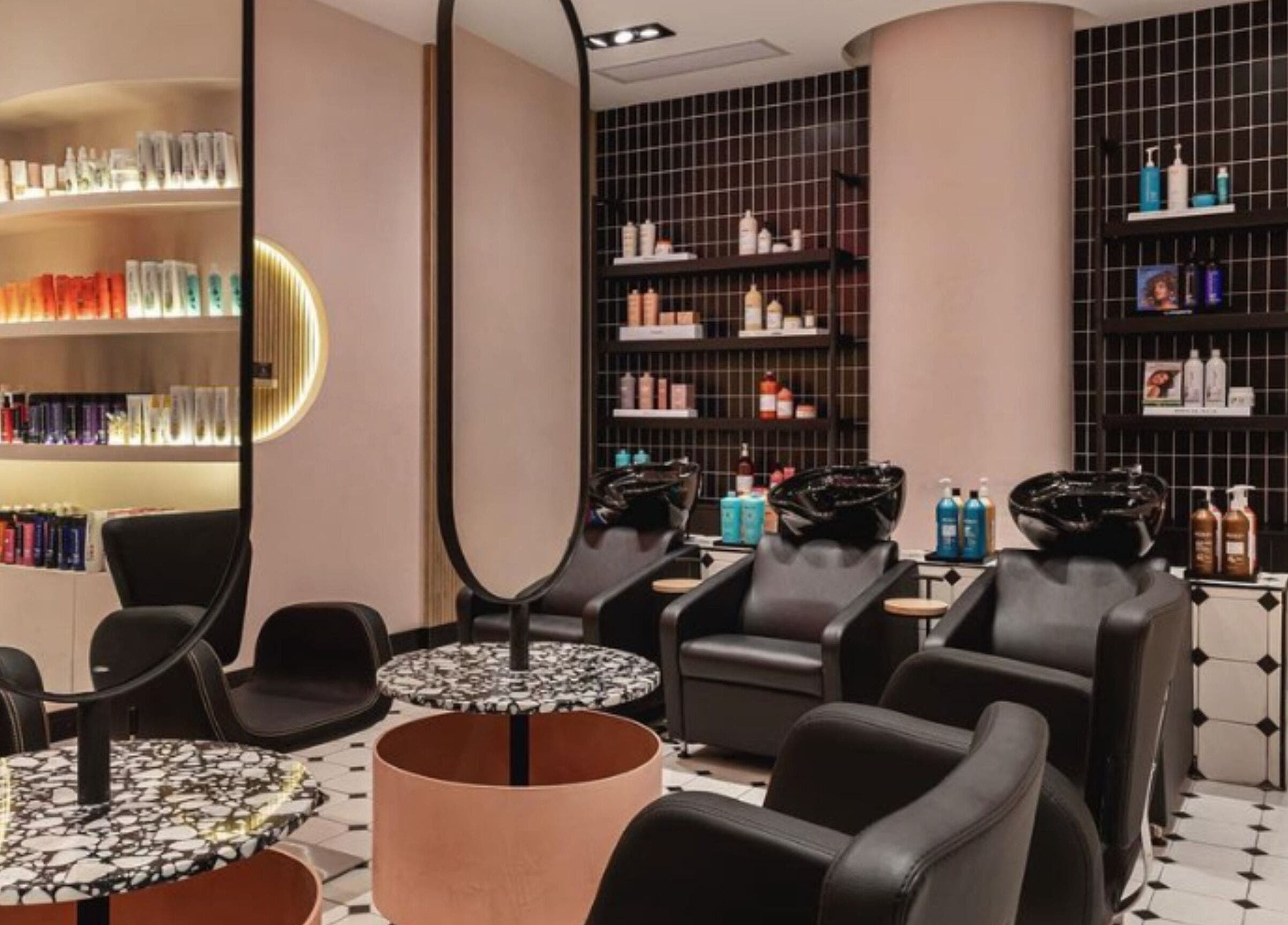 Modern salon interior at The Beauty Lab - Los Cacicazgos, Santo Domingo highlighting sleek styling chairs and products.