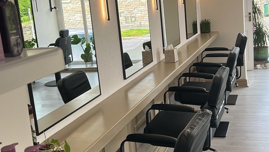 Stylish salon interior with sleek chairs and mirrors at Danielle Harrison hair.makeup.bridal, Rawtenstall, England, GB.