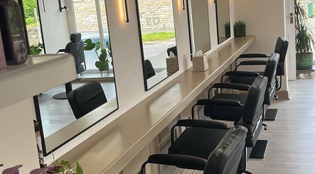 Stylish salon interior with sleek chairs and mirrors at Danielle Harrison hair.makeup.bridal, Rawtenstall, England, GB.