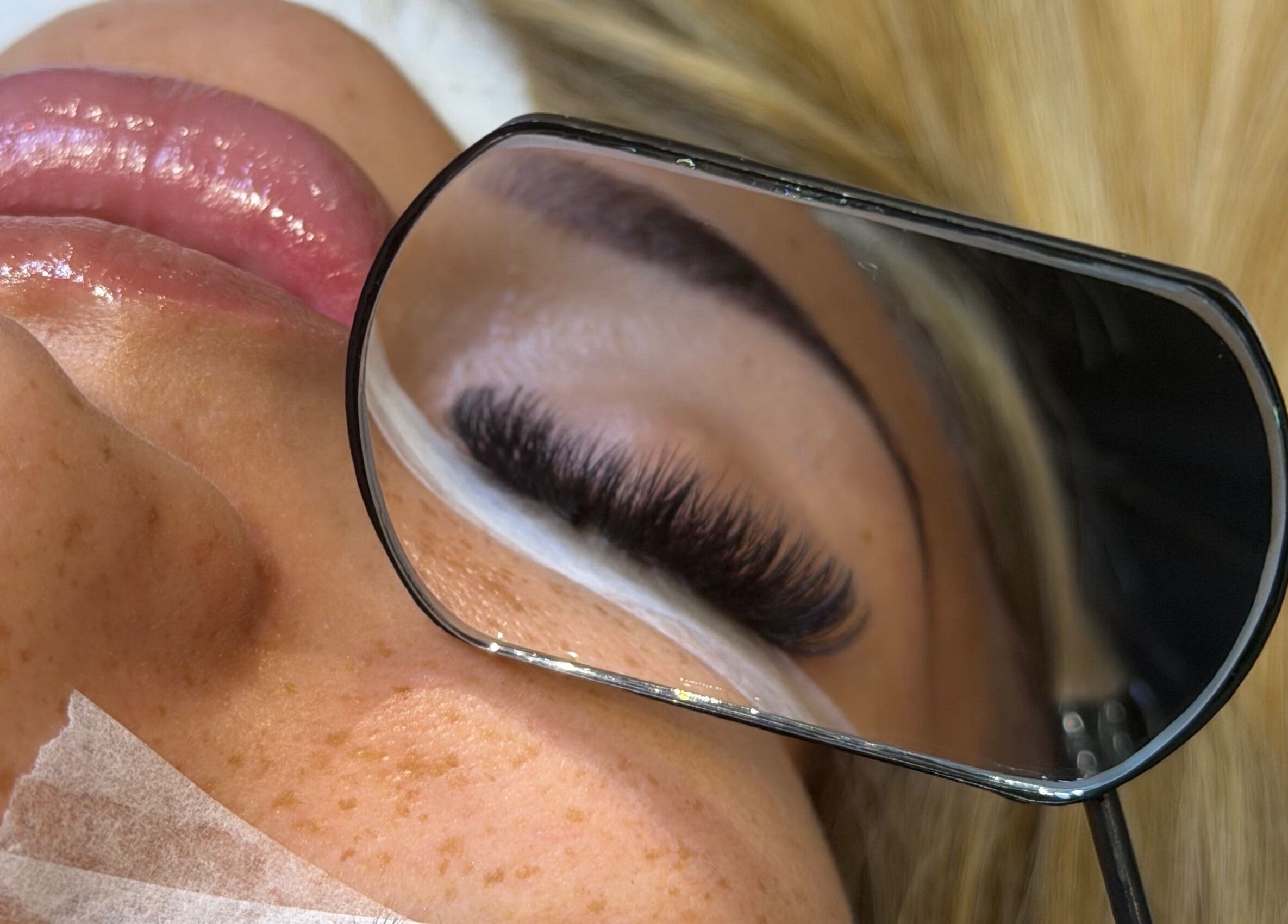Close-up of eyelash extension at FLD Beauty, Stansted Mountfitchet, England, GB in a hand-held mirror.