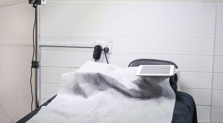 Treatment bed with tablet at Besighini Beauty, Maroubra, New South Wales, AU. Modern and inviting wellness setup.