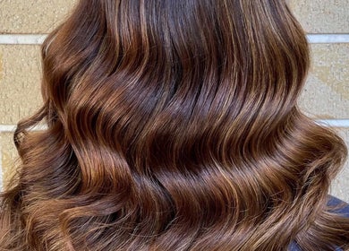 Elegant, shiny brown waves styled at Studio Marianna in Holland Park West, Queensland, AU.