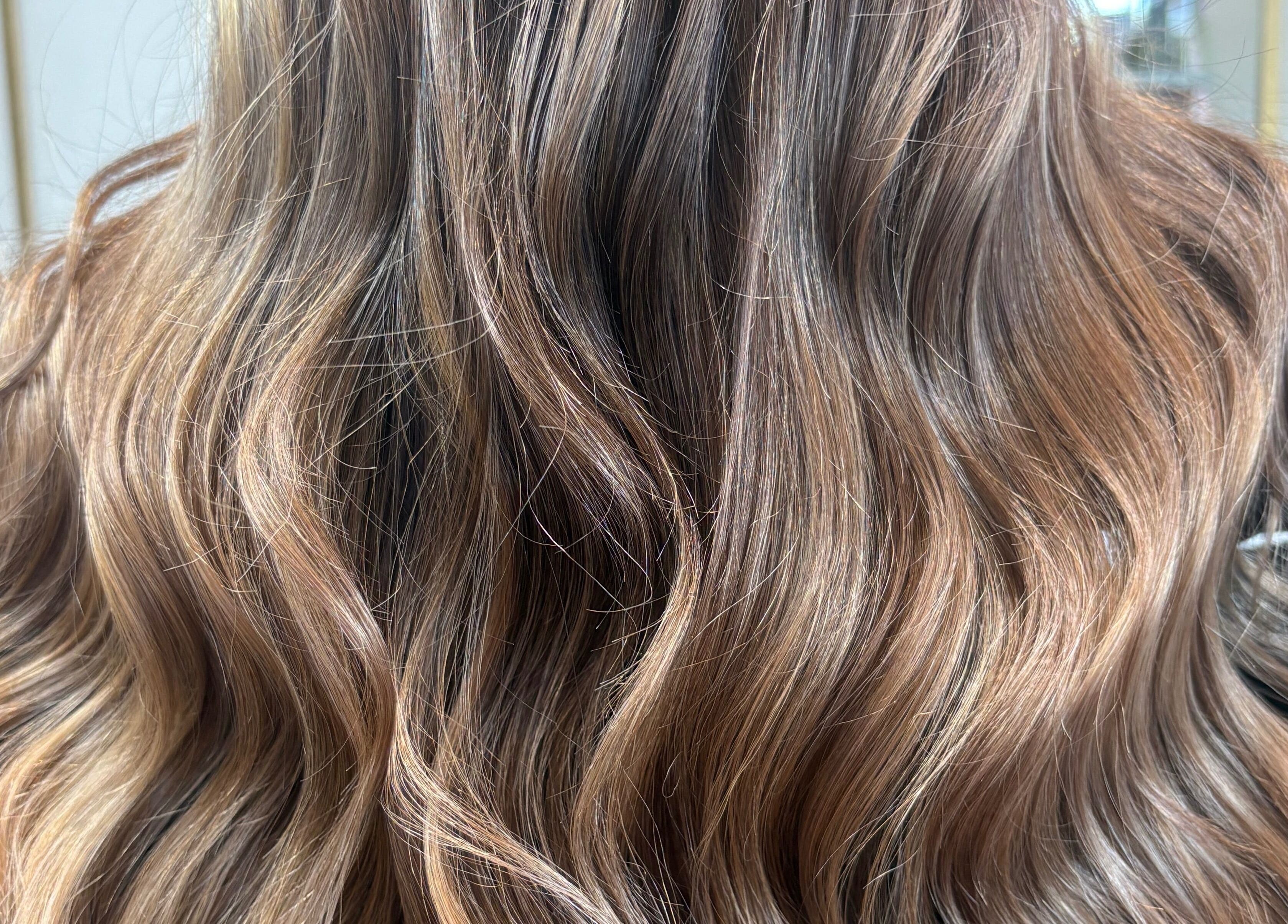Luxurious wavy hairstyle at The Vanity in Turvey Park, New South Wales, AU, showcasing rich balayage tones.
