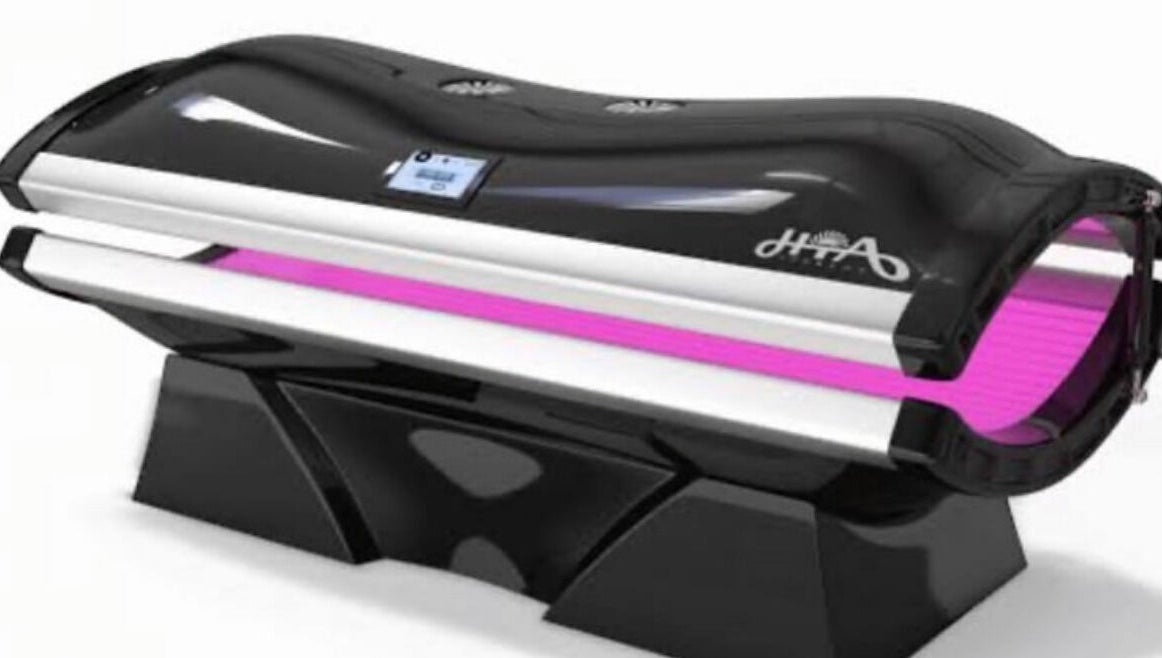 High-tech tanning bed at CS Tan, Melbourne, Victoria, AU. Sleek design with vibrant purple lighting.