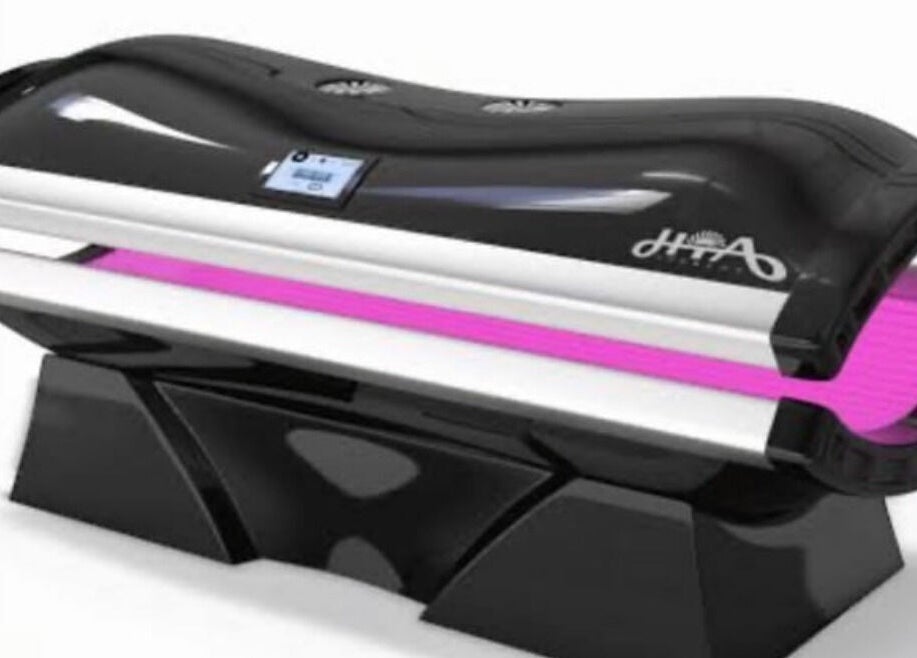 High-tech tanning bed at CS Tan, Melbourne, Victoria, AU. Sleek design with vibrant purple lighting.