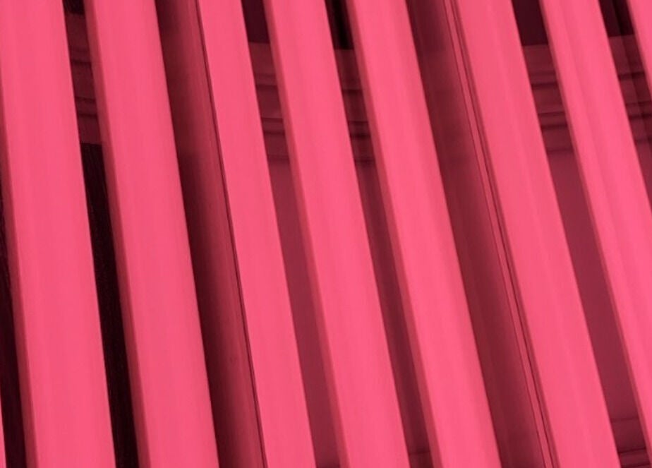 Radiant pink vertical lights at CS Tan in Melbourne, Victoria, AU create a warm, inviting ambiance.