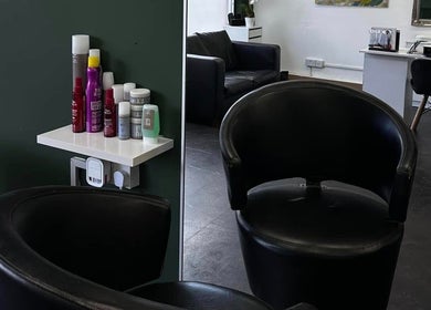 Elegant salon interior at SORSIA, Bournemouth, England, GB featuring modern chairs and beauty products.
