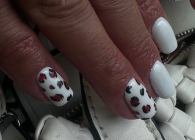 Elegant white nail art with leopard spots at SORSIA, Bournemouth, England, GB.