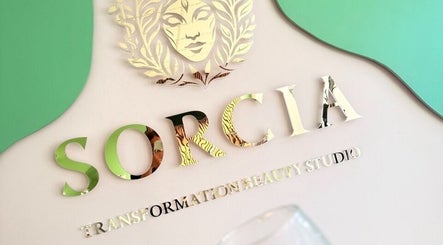 SORCIA beauty studio logo at Bournemouth, England, GB. Stylish wall art with green and gold design.