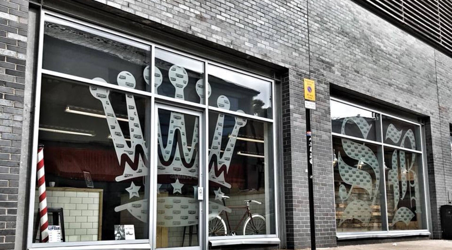 Exterior of SB Barbering Academy Sunderland at Sunderland, England, GB with unique window designs.