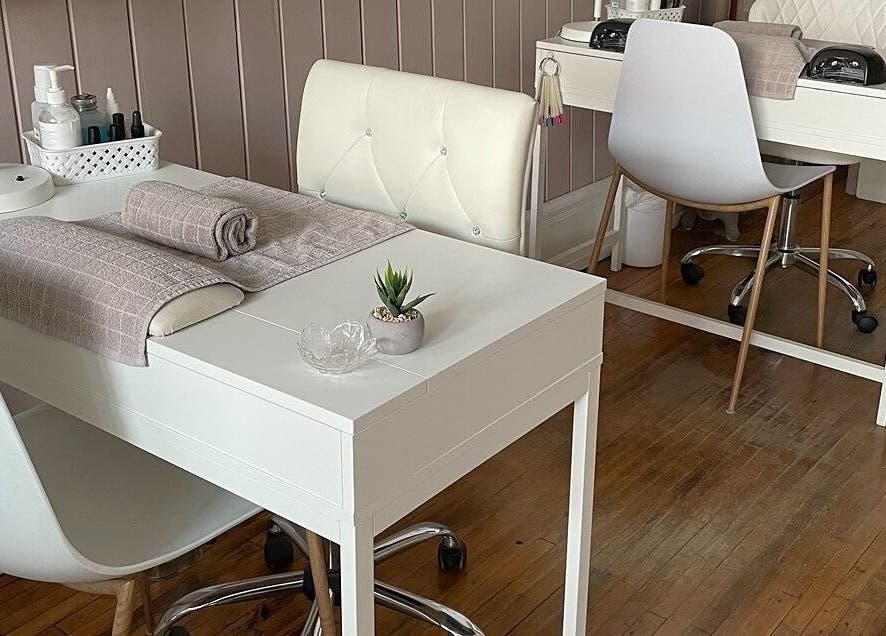 Modern manicure stations at Sundara Spa, Midland, Ontario, CA, featuring plush chairs and elegant decor.