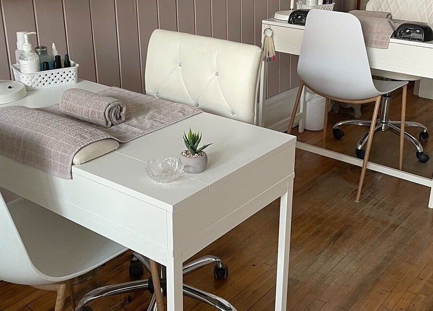 Modern manicure stations at Sundara Spa, Midland, Ontario, CA, featuring plush chairs and elegant decor.