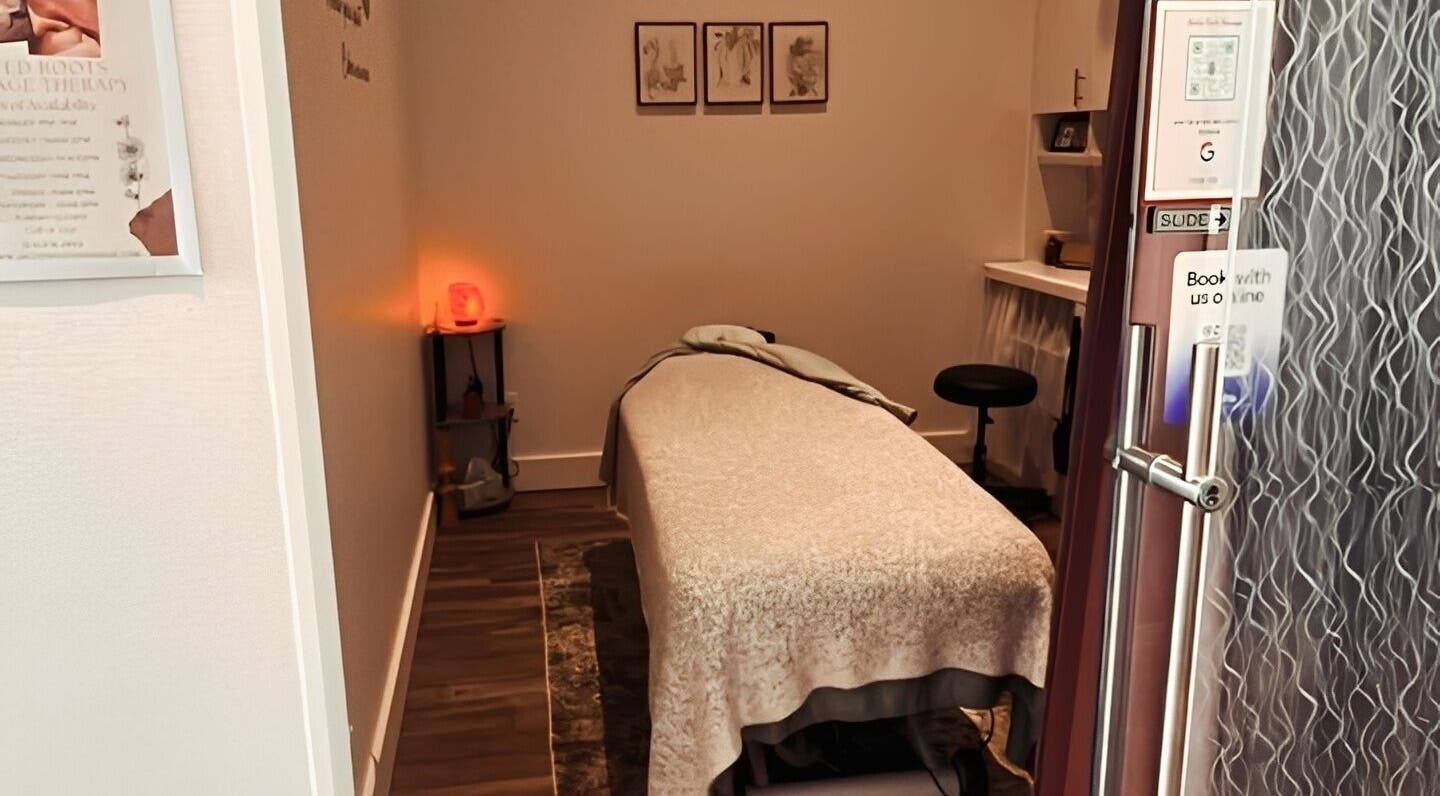Cozy massage room at United Roots Massage, North Massapequa, New York, US with relaxing decor.