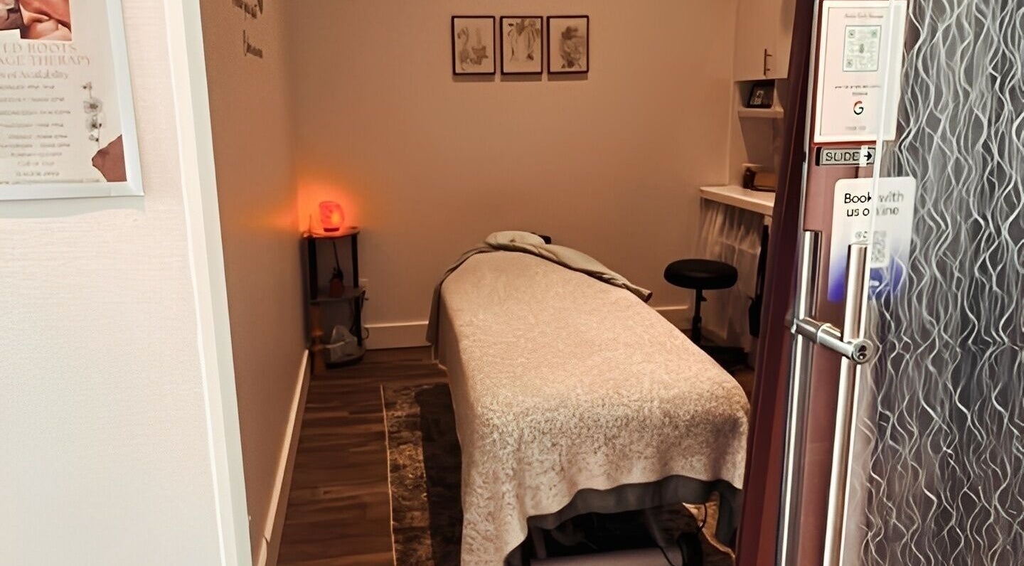 Cozy massage room at United Roots Massage, North Massapequa, New York, US with relaxing decor.
