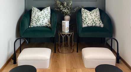 Elegant seating at The Skin Firm in Cape Town, Western Cape, ZA. Lush pillows and chic decor set a calming vibe.