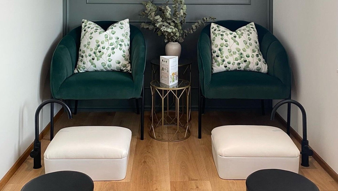 Elegant waiting area with green chairs at The Skin Firm, Cape Town, Western Cape, ZA.