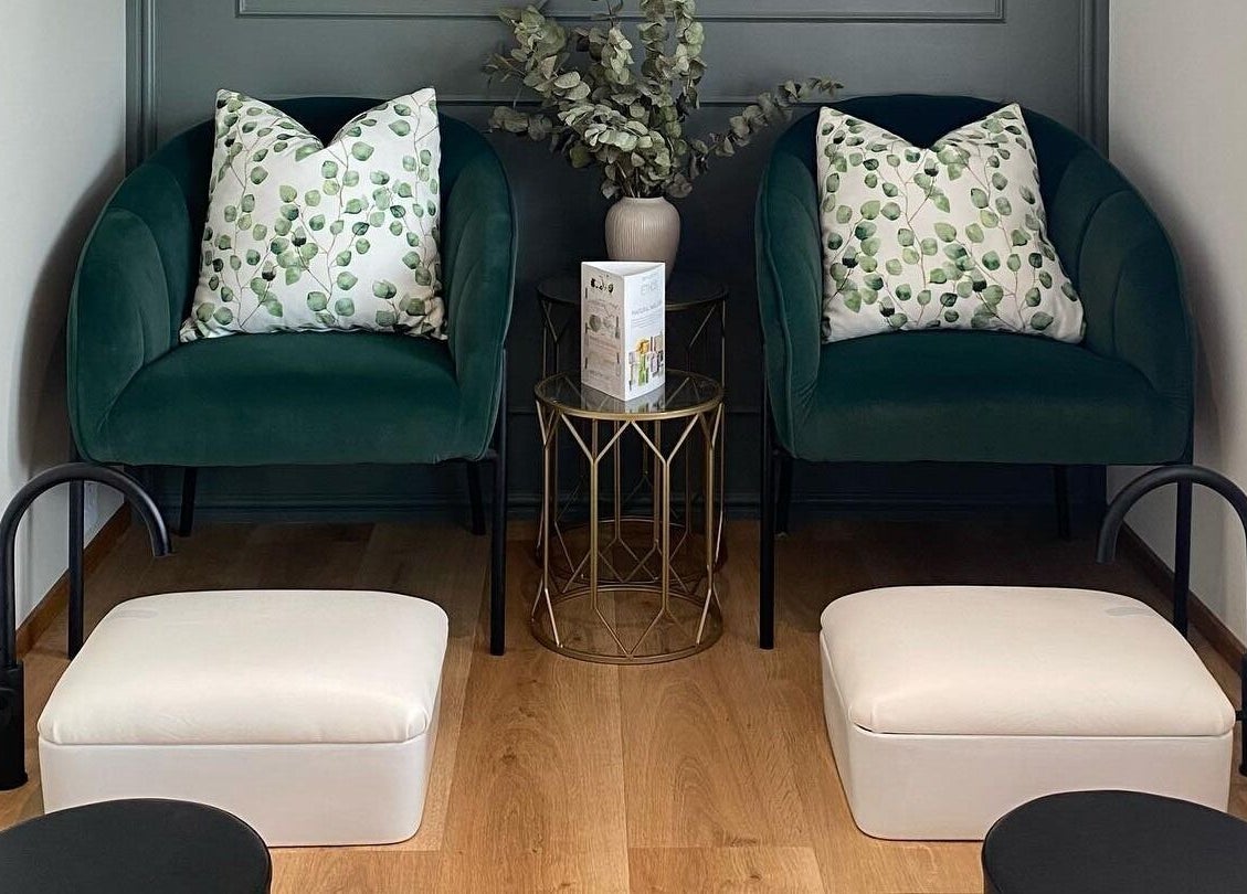 Elegant waiting area with green chairs at The Skin Firm, Cape Town, Western Cape, ZA.