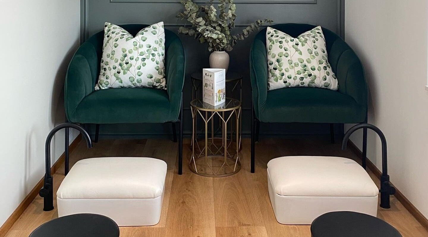 Elegant waiting area with green chairs at The Skin Firm, Cape Town, Western Cape, ZA.