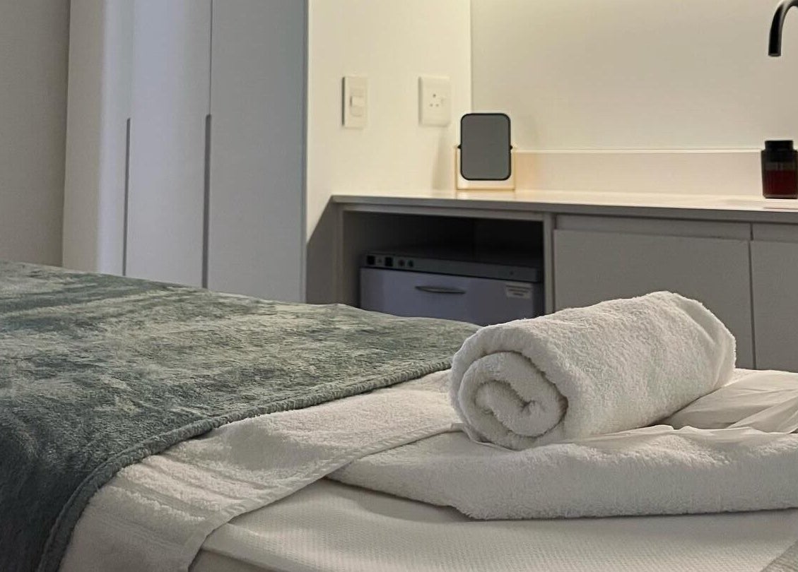 Relaxing treatment room at The Skin Firm, Cape Town, Western Cape, ZA with plush towels and modern amenities.