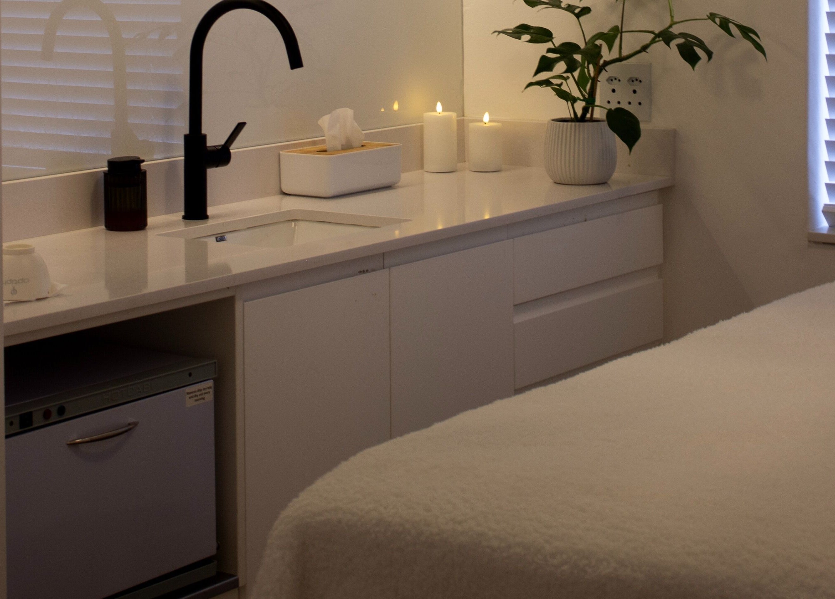 Relaxing spa room at The Skin Firm, Cape Town. Cozy and inviting, ideal for wellness treatments.