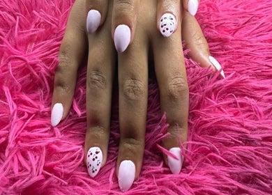 Elegant manicured nails on vibrant pink fur at The Beauty Box, Cape Town, Western Cape, ZA.