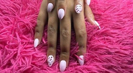 Elegant manicured nails on vibrant pink fur at The Beauty Box, Cape Town, Western Cape, ZA.