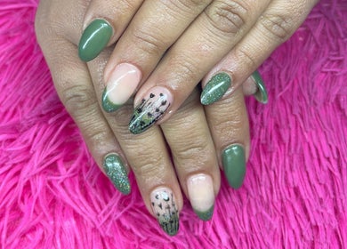 Stylish green manicure at The Beauty Box, Cape Town, Western Cape, ZA on a pink background.