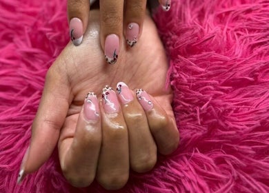 Elegant manicure at The Beauty Box, Cape Town, Western Cape, ZA. Pink nails with art against a plush pink background.