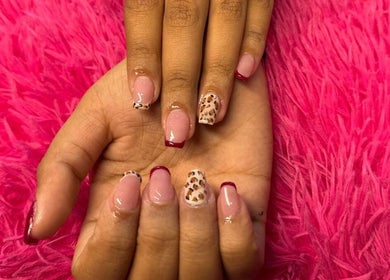 Stylish leopard and red-accented nails from The Beauty Box in Cape Town, Western Cape, ZA.