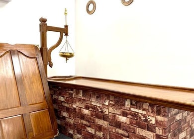 Traditional wooden massage table at The Indian Spa in Cardiff, Wales, GB, offering authentic wellness treatments.