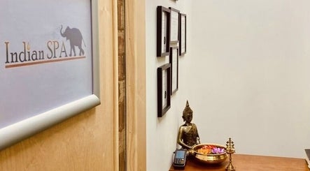 Entrance decor of The Indian Spa, featuring a Buddha statue and wall art in Cardiff, Wales, GB.